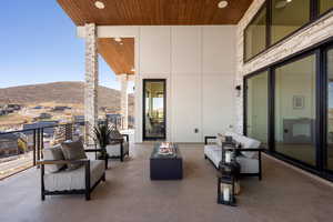 View of patio / terrace featuring a mountain view and an outdoor living space with a fire pit