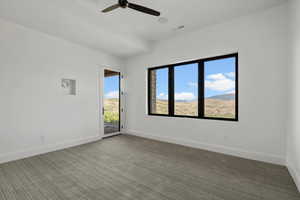 Carpeted spare room featuring ceiling fan and a mountain view