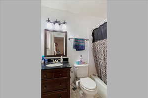 Full bathroom featuring vanity, tile patterned floors, and shower / bathtub combination with curtain