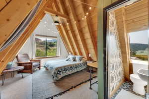 Carpeted bedroom featuring wooden walls