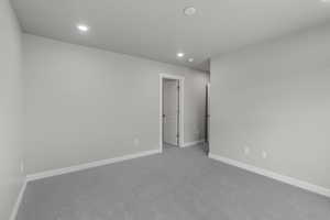 Empty room featuring recessed lighting and carpet floors