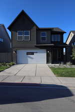 View of front of home featuring an attached garage and driveway