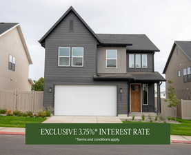 View of front of house featuring a garage, driveway, and roof with shingles