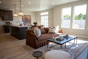 Living room featuring light wood-type flooring and recessed lighting