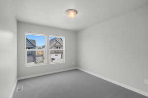 Unfurnished room with carpet floors and a textured ceiling