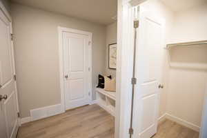 Corridor featuring light wood finished floors and baseboards