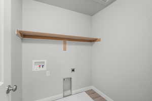 Laundry area featuring hookup for a washing machine, light wood-style flooring, and hookup for an electric dryer