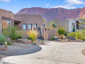 View of front of house featuring stucco siding and a mountain view