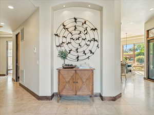Corridor with recessed lighting and light tile patterned floors