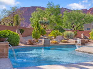 View of swimming pool featuring a fenced backyard and a mountain view