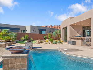 View of swimming pool featuring a patio area and an outdoor fire pit
