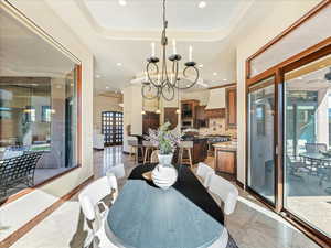 Dining space with recessed lighting and a chandelier
