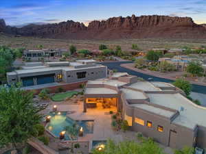 Aerial view of property and surrounding area featuring a mountainous background