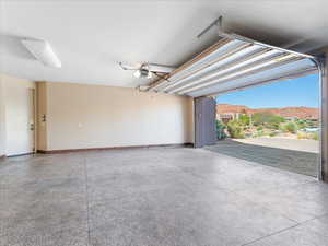Garage with baseboards and a garage door opener