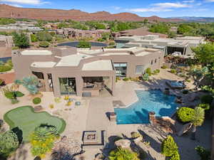 Swimming pool featuring a mountain view, a patio area, and a residential view