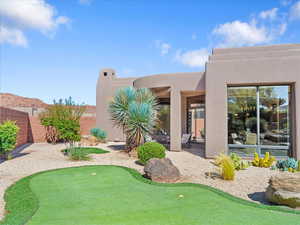 View of yard featuring an area to practice putting and a patio area