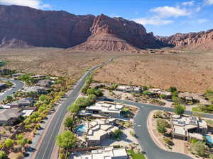 Aerial overview of property's location featuring nearby suburban area and a mountainous background