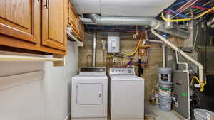 Laundry and mechanical area with on-demand hot water, basement