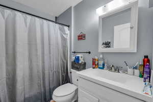 Full bathroom featuring vanity and a shower with shower curtain