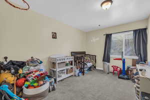 Bedroom featuring carpet flooring and baseboards