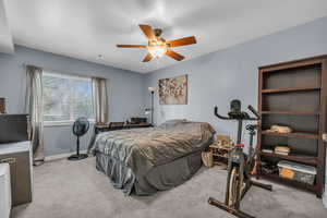 Carpeted bedroom with baseboards and ceiling fan