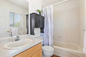 Bathroom with vanity and shower / bath combo with shower curtain