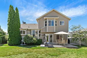 Back of property with a patio and french doors