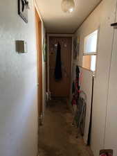 Hall featuring concrete flooring and a textured ceiling
