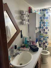 Full bathroom featuring a textured ceiling, vanity, ornamental molding, and shower / tub combo