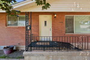 Entrance to property featuring brick siding