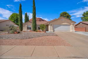 Mediterranean / spanish home featuring stucco siding, a tiled roof, concrete driveway, a garage, and a mountain view
