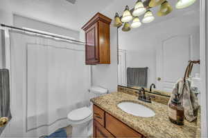 Bathroom featuring vanity and shower / bath combo with shower curtain