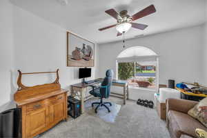 Office area featuring light colored carpet and ceiling fan