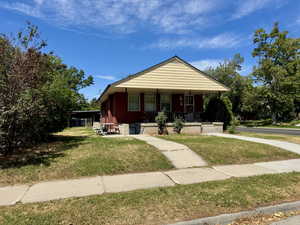 Bungalow-style house with covered porch and a front yard