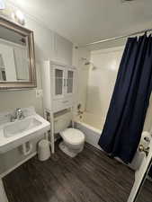 Spare room featuring dark carpet and a paneled ceiling