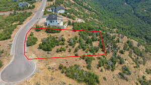 Aerial view of property and surrounding area with property parcel outlined
