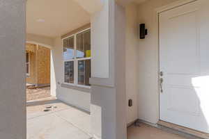 Entrance to property with stucco siding