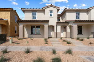 Mediterranean / spanish house with stucco siding, a tile roof, and a porch