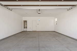 Garage with electric water heater and baseboards