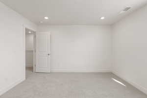 Unfurnished room with light carpet and recessed lighting