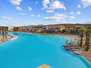 Community pool featuring a residential view, a mountain view, and a patio