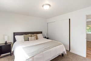 Primary bedroom featuring a closet and baseboards