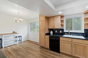 Kitchen featuring appliances with stainless steel finishes, light wood finished floors, decorative backsplash, a raised ceiling, and recessed lighting