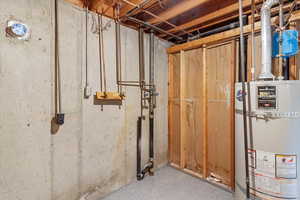 Unfinished basement with strapped water heater
