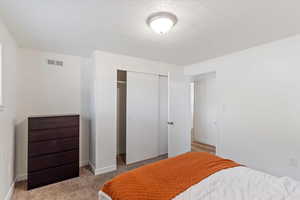 Bedroom featuring a closet and carpet flooring