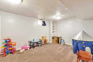 Rec room featuring carpet flooring and baseboards