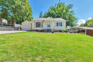 View of front of house with a front yard, driveway, and roof with shingles