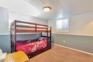 Carpeted bedroom with baseboards