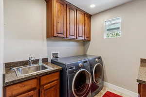 Laundry area featuring cabinet space, washing machine and dryer, light tile patterned flooring, and recessed lighting