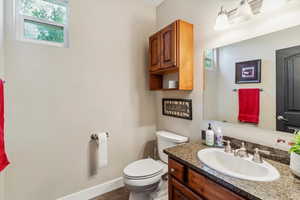 Half bathroom featuring toilet and vanity